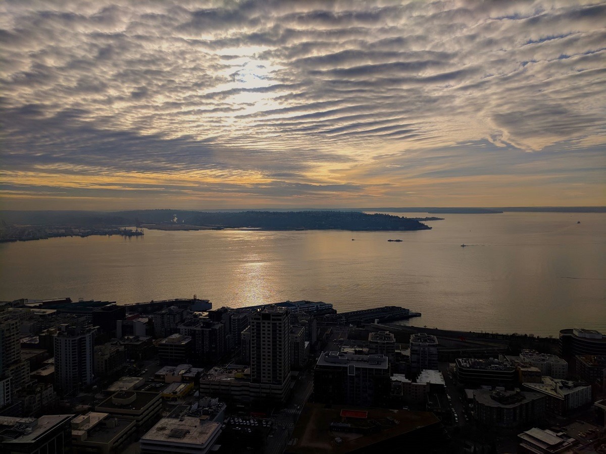 Sun setting through cirrus clouds over Elliot Bay in Seattle